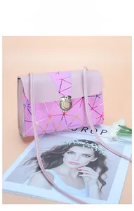Macro detail of pink crossbody bag featuring geometric laser lines and croc-embossed flap