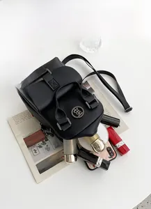 Detail of black leather crossbody bag showing inner storage for phone and cosmetics