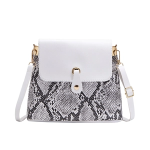 Snake skin pattern crossbody bag with white flap and gold metal clasp on white background