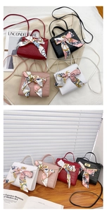 Close-up of crocodile pattern handbags with floral silk scarves and metallic locks