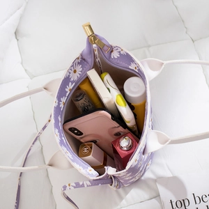 Purple daisy canvas bucket bag showing large capacity with daily essentials inside