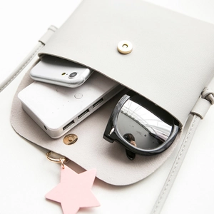 Light gray small PU leather crossbody bag with star charm and interior storage capacity