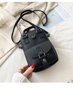 Detailed macro view of black lychee grain mini handbag with metal TB logo and buckle