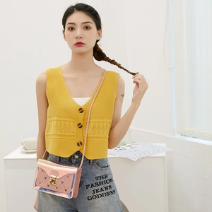 Pink holographic crossbody bag with heart cutout and metal lock shown on a model