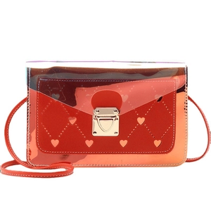 Orange heart-patterned crossbody bag with gold lock and transparent PVC contrast
