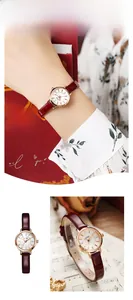 Detail view of a small round women's quartz watch with a burgundy leather strap