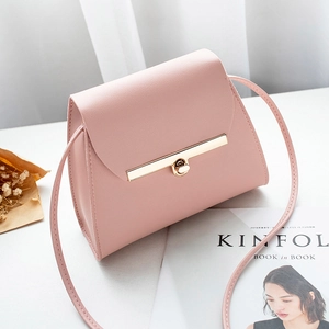Light pink leather crossbody bag with golden twist lock and thin shoulder strap
