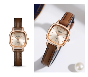 Detail of square champagne dial with rose gold case and brown leather strap on luxury watch