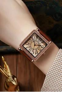 Close-up of vintage square quartz watch with diamond bezel and brown leather strap