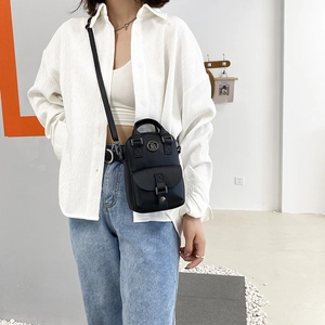 Mini black synthetic leather crossbody bag with top handle and stylish buckle detail