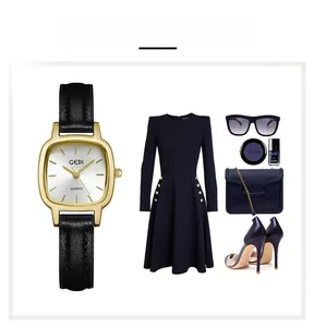 Close-up of golden square quartz watch with black leather strap and stylish outfit items