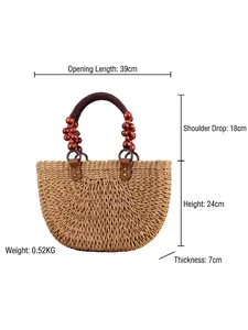Handwoven semi-circle straw tote bag with brown fabric handles and red wooden beads