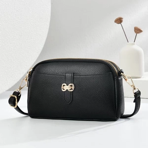 Classic black litchi texture crossbody bag with gold hardware and butterfly buckle decor