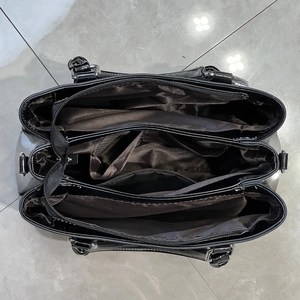 Top view of large tote bag interior showing three main compartments and silver buckles