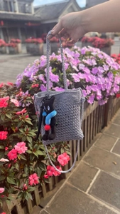 Handcrafted crochet bag in silver-gray with a cute black cat plush charm detail