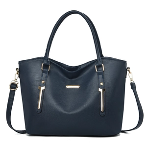 Detail shot of navy blue faux leather tote showing fine litchi texture and gold metal plate
