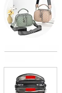 Detail view of large capacity quilted crossbody bag with triple zippers and wide strap