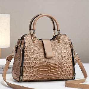 Detail view of the elegant apricot crocodile pattern texture and golden hardware accents