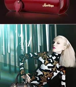 Close-up of glossy red leather handbag with leaf charm and black crossbody purse detail