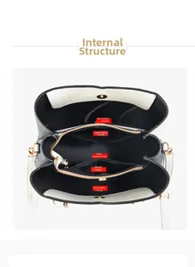 Detail view showing internal compartments and golden hardware of woman's tote bag