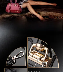 Detail of red glossy patent leather handbag showing golden hardware and leaf charm