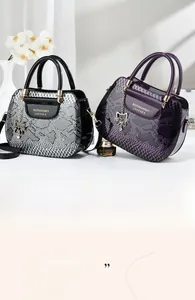 Close-up of luxury snakeskin embossed leather tote bags with metal cat charms