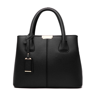 Chic black lychee grain leather handbag with gold buckles and vertical stitching design