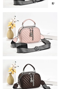 Detail of quilted leather handbag with detachable wide woven strap and silver bear charm