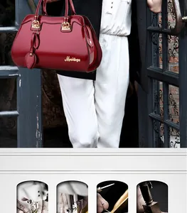 Detail of dark red glossy patent leather handbag with gold hardware and leaf charm