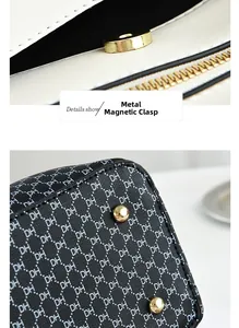 Detail showing high-quality golden magnetic buckle and DH letter jacquard fabric texture