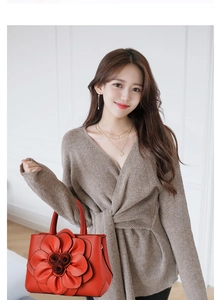 Detail of red leather tote bag featuring large 3D rose floral design for women