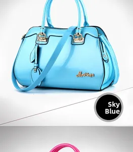 Detail of glossy sky blue patent leather handbag with gold metal hardware and leaf charm