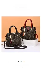 Detail of the cat pendant and gold DIALD letter print on these stylish shoulder bags