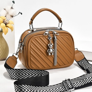 Brown quilted crossbody bag with three zip compartments and stylish wide strap