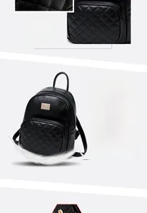 Dettaglio ravvicinato di uno zaino trapuntato nero con logo in metallo dorato e zip