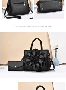 Detail of black faux leather tote set with 3D flower, gold hardware, and metal base studs