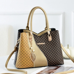 Elegant monogram handbag for women in brown and gold with luxury leaf charm and shoulder strap