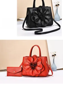 Detailed close-up of handbags with 3D leather flower design and adjustable straps