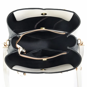 Overhead view of white leather tote bag with multi-compartment interior and gold hardware