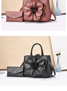 Detail of elegant two-piece handbag set featuring a 3D floral accent and envelope pouch
