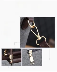 Détail de la ferrure plaquée or et de la fermeture éclair sur sac à main en cuir gris