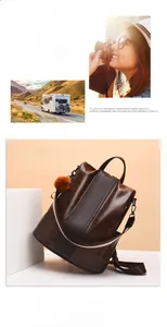Close-up of vintage brown pebble leather backpack with decorative fur ball and side buckle