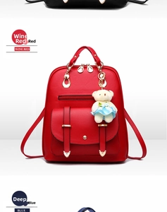 Detail view of wine red PU leather backpack with front pocket and plush bear pendant