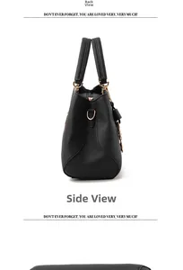 Detail view of black pebbled leather handbag with elegant gold metal D-ring attachment