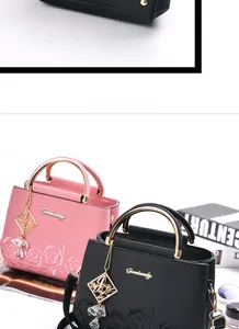 Detail of rose embroidery and lychee texture on luxury handbags with gold handles