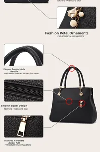 Close-up of black litchi pattern leather handbag with gold zipper and petal pearl charm
