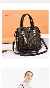 Detail showing dark brown faux leather bag with letter prints and cat tassel charm