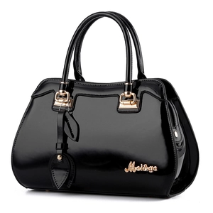 Black glossy patent leather handbag with gold hardware and embossed metal logo