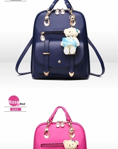 Detailed view of PU leather backpacks in navy blue and rose red with plush bear charms
