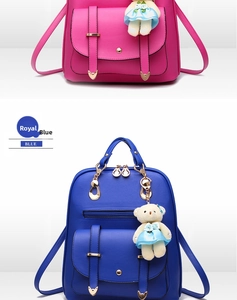 Detail view of stylish PU leather backpacks in rose red and blue with cute bear pendant
